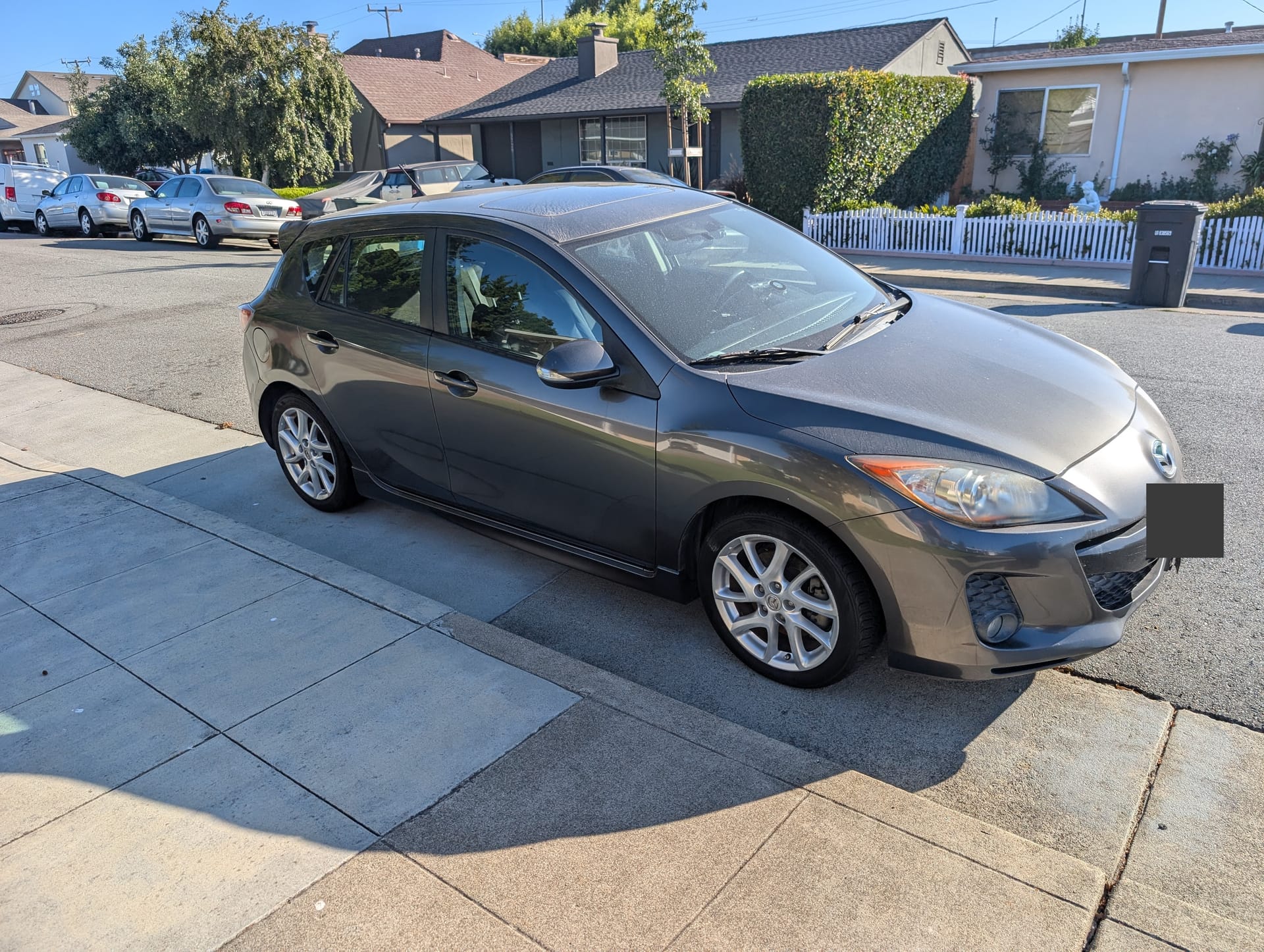 2012 Mazda3 s Touring hatchback in Graphite Mica gray, parked, three-quarter front view